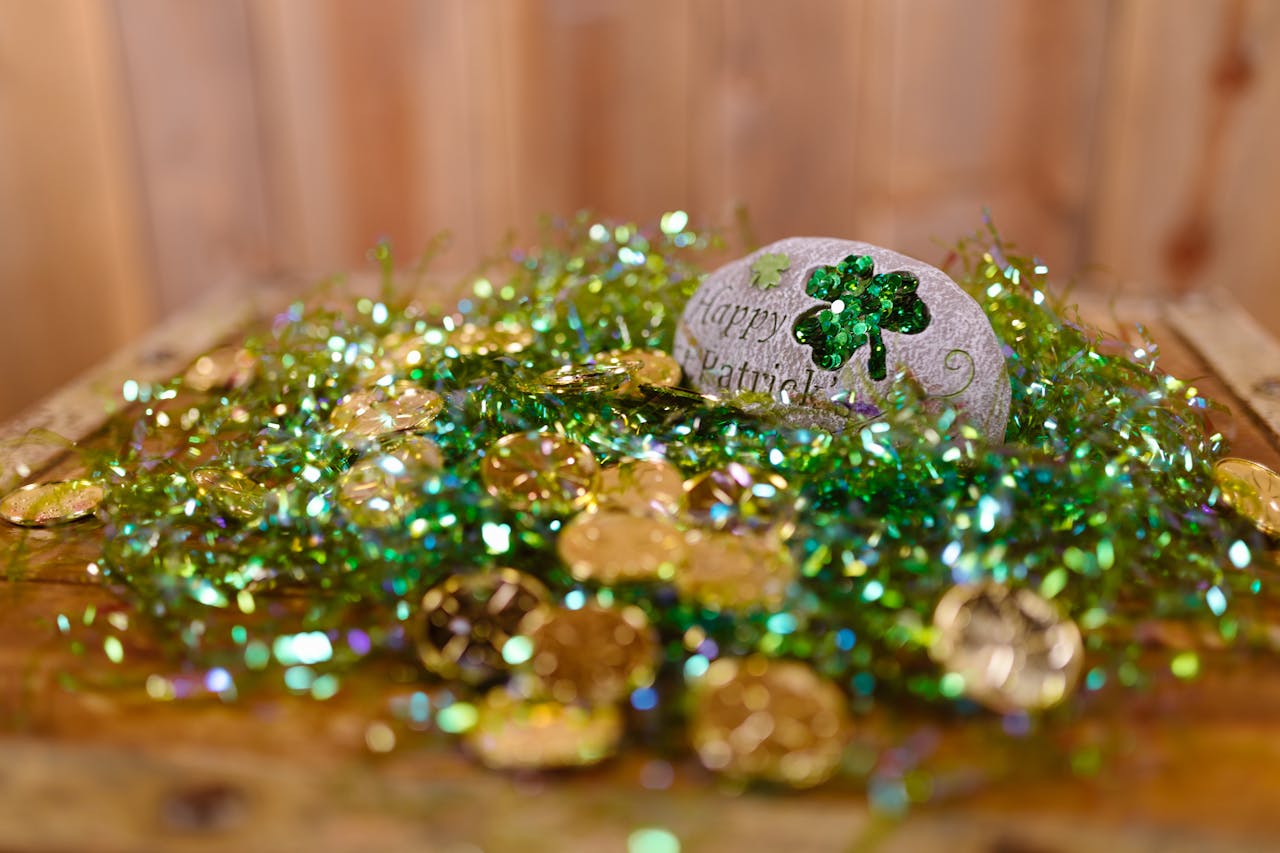 Vibrant St. Patrick's Day decor featuring gold coins and shamrock embellishments on a wooden table.